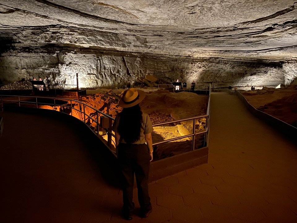 A park ranger standing in front of the main lodge building
