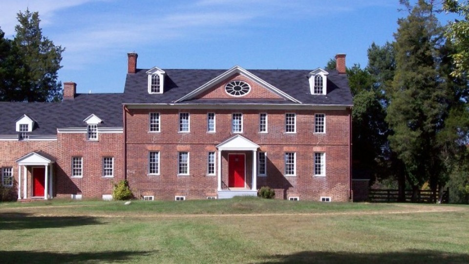 black and white photo of a brick manor