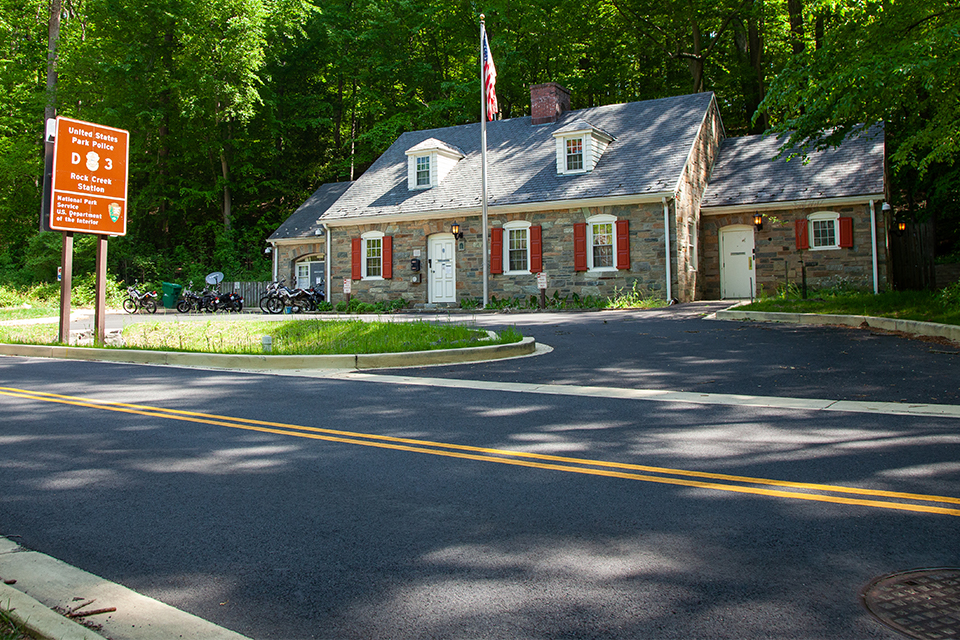 Potholes and patches on road near US Park Police Station in Rock Creek Park
