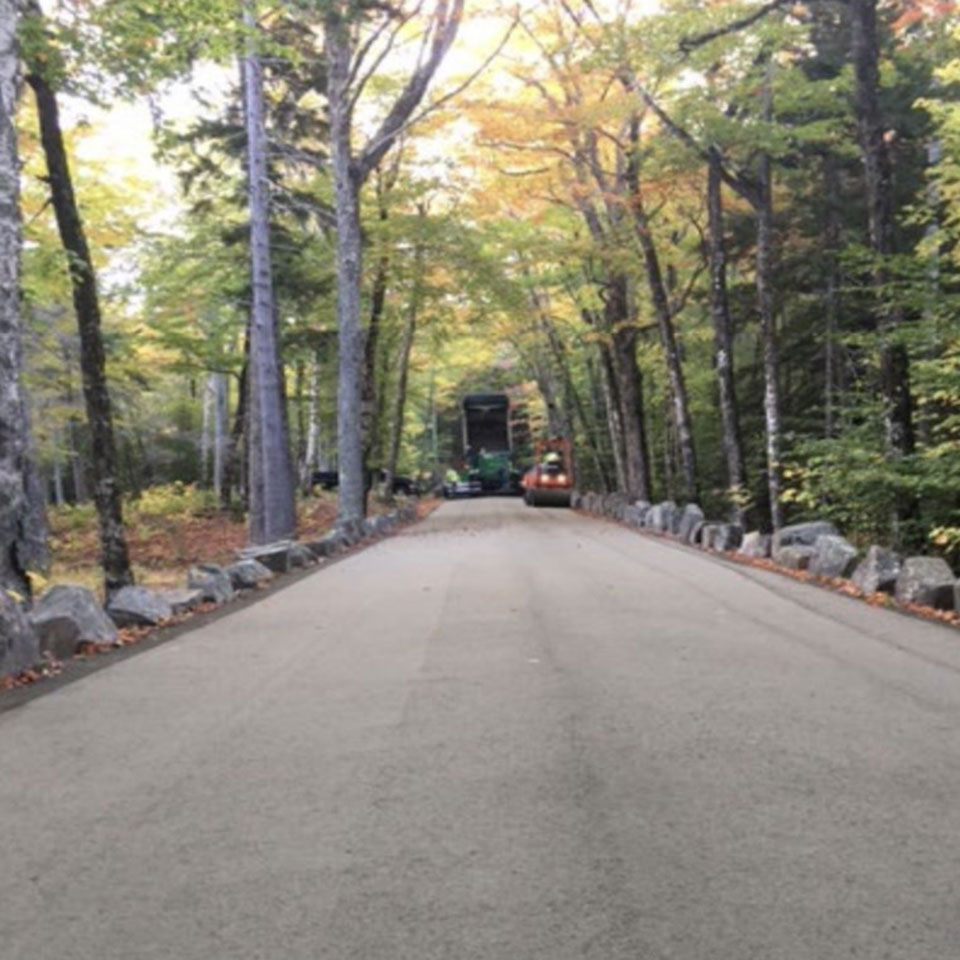 a heavy machine works along rough carriage road