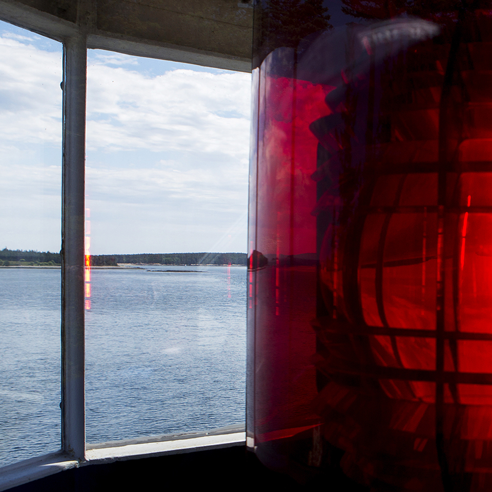 Lighthouse tower with red cone around light