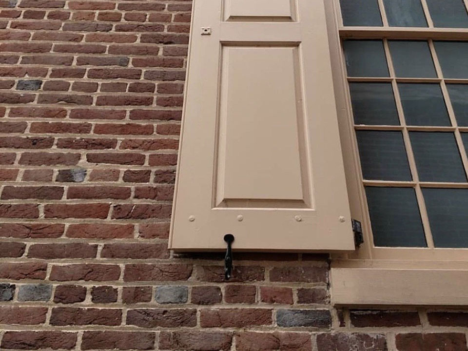 long, metal object with decorative circle on one end and a point at the other