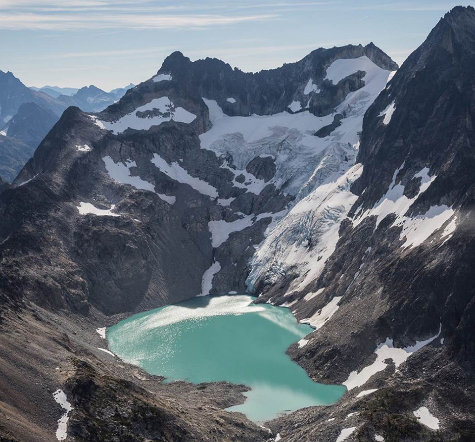 Black-and-white photo of a glacier extending to the bottom of the frame