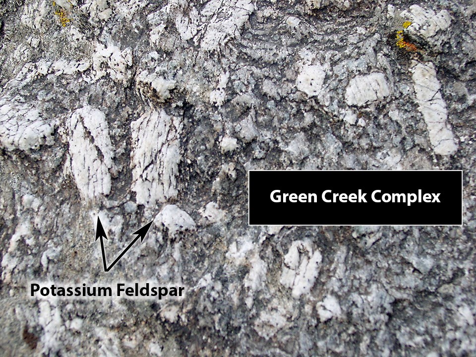 Dark gray granite with large white crystals of potassium feldspar.