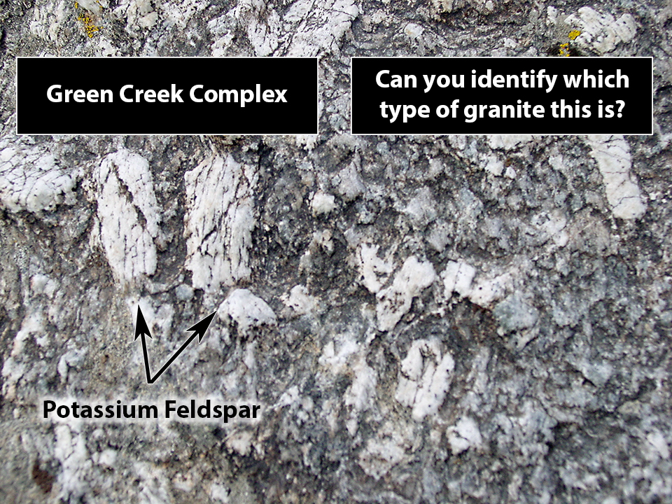 Dark gray granite with large white crystals of potassium feldspar.