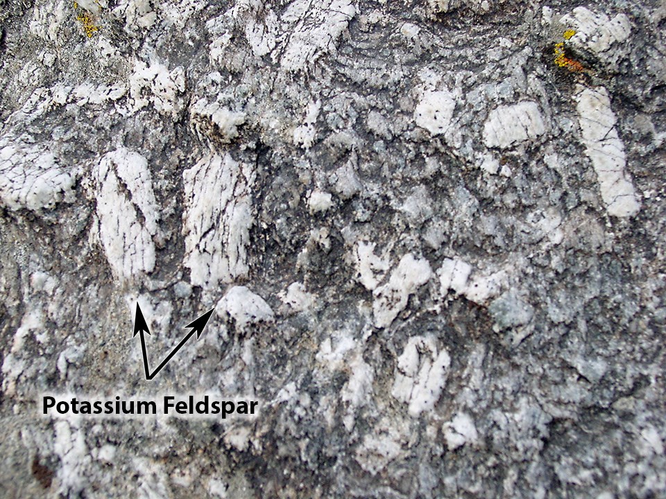 Green Creek Complex - Dark gray granite with large white crystals of potassium feldspar.