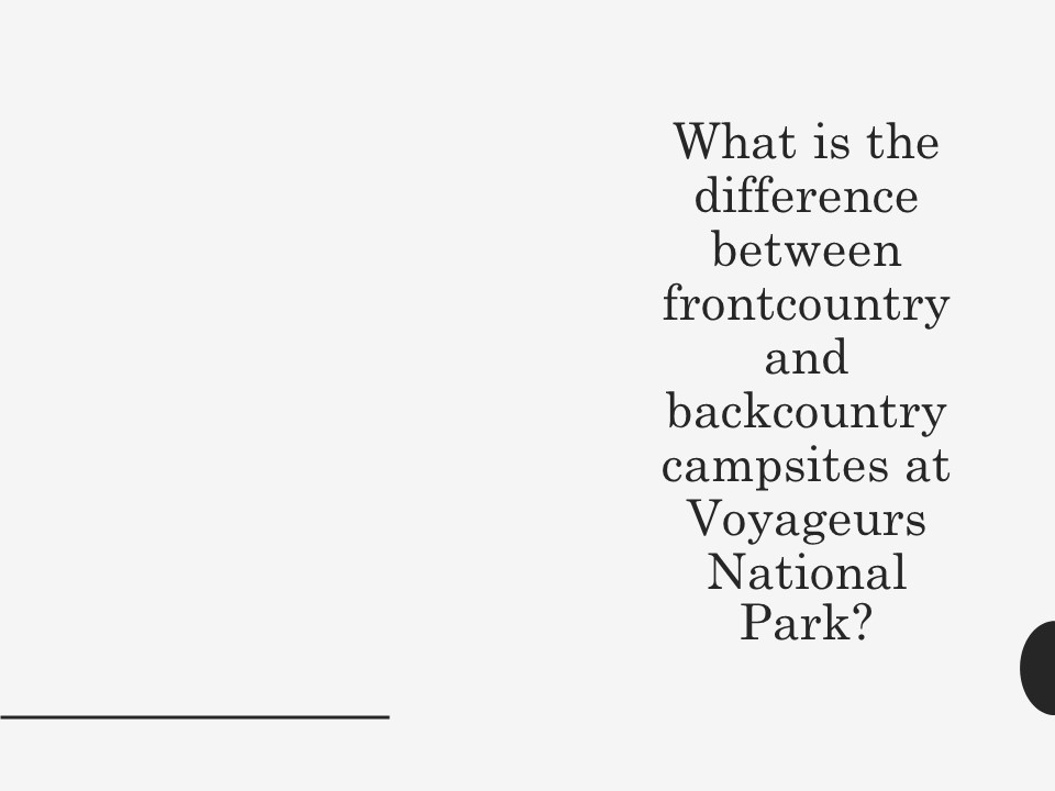 A canoe with the national park service logo sits in the water.