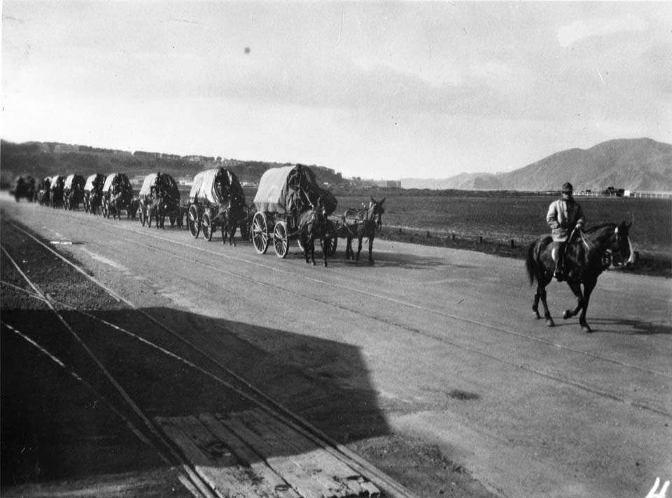 cars on the street with the golden gate bridge in the background