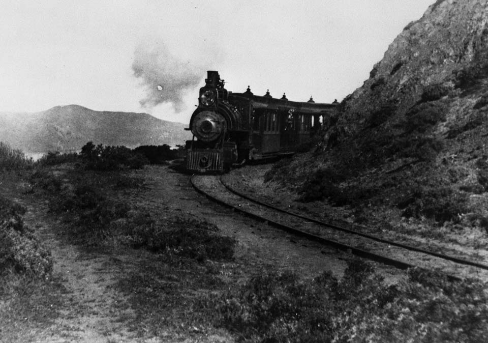 three people walk around a corner