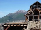 dilapidated wood building in a mountainous setting