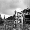 An anthropologist in front of a cabin.