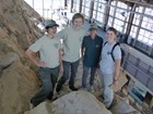 4 interns on large quarry wall in visitor center