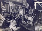 Women wave American flags and blow horns in celebration. Bryn Mawr College