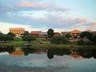 historic homes, buildings, and trees reflecting in the river