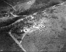 aerial view of a tent camp near a creek