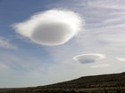 Two rounded clouds called lenticulars that look like space ships.