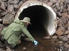 collecting water samples at an outfall
