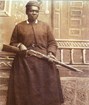 Photo of a woman holding a gun. 