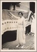 Woman raising cup with flag in background. Library of Congress. 