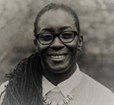 Headshot of African American woman wearing glasses smiling
