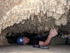 person lying on back measuring cave turnips