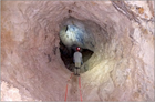 Staff member standing in the Gypsum Annex in a passage that is covered in gypsum.
