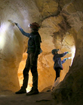Two volunteers cleaning lint off the walls in part of Lehman Caves known as the Giant's Ear