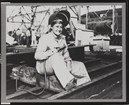 Black and white photo of white woman in welding gear 