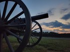 Morning light over field, cannon in foreground.