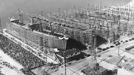 Row of large ships with scaffolding