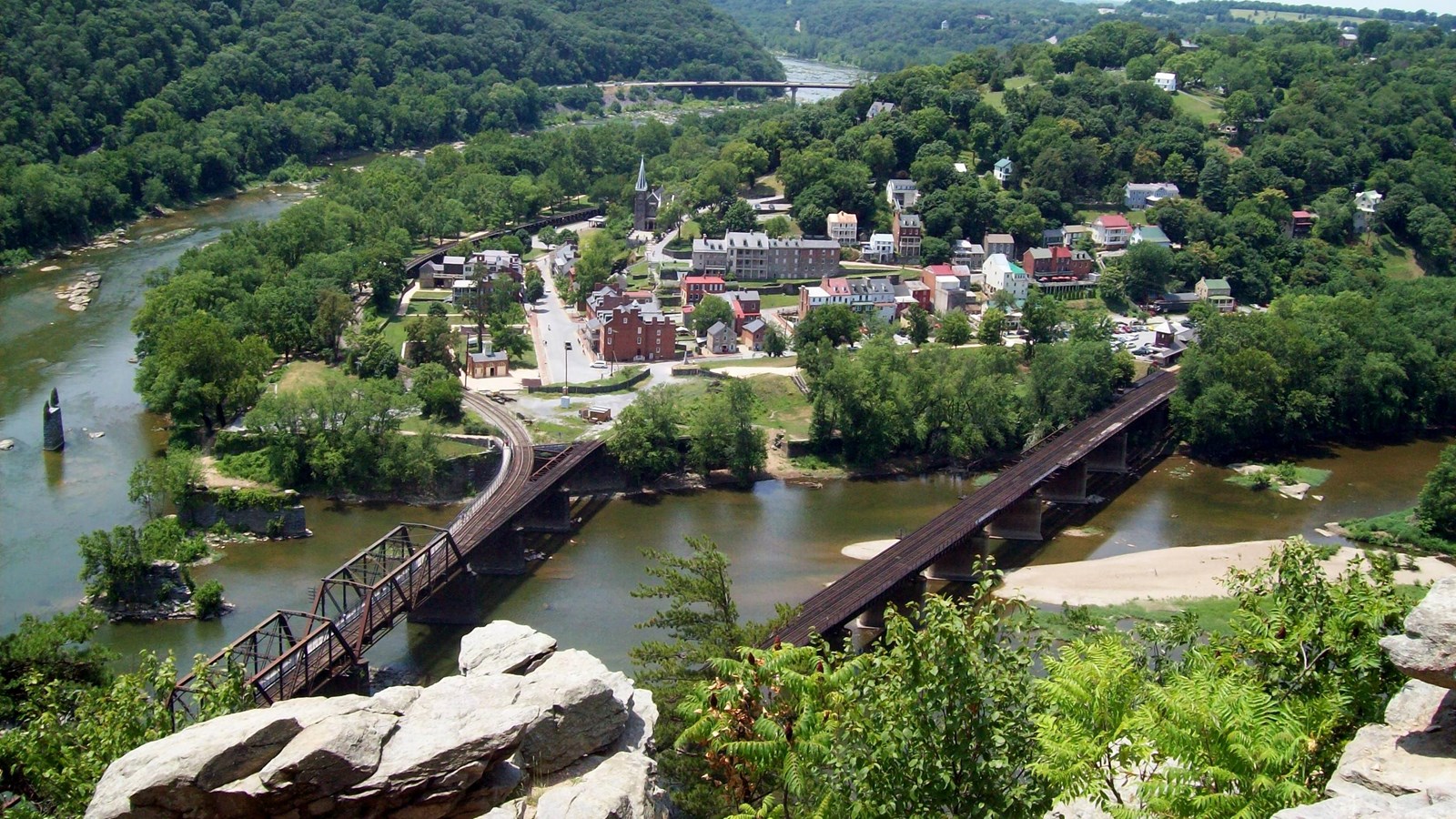 View overlooking two bridges leading to a historic town with colorful budlings 