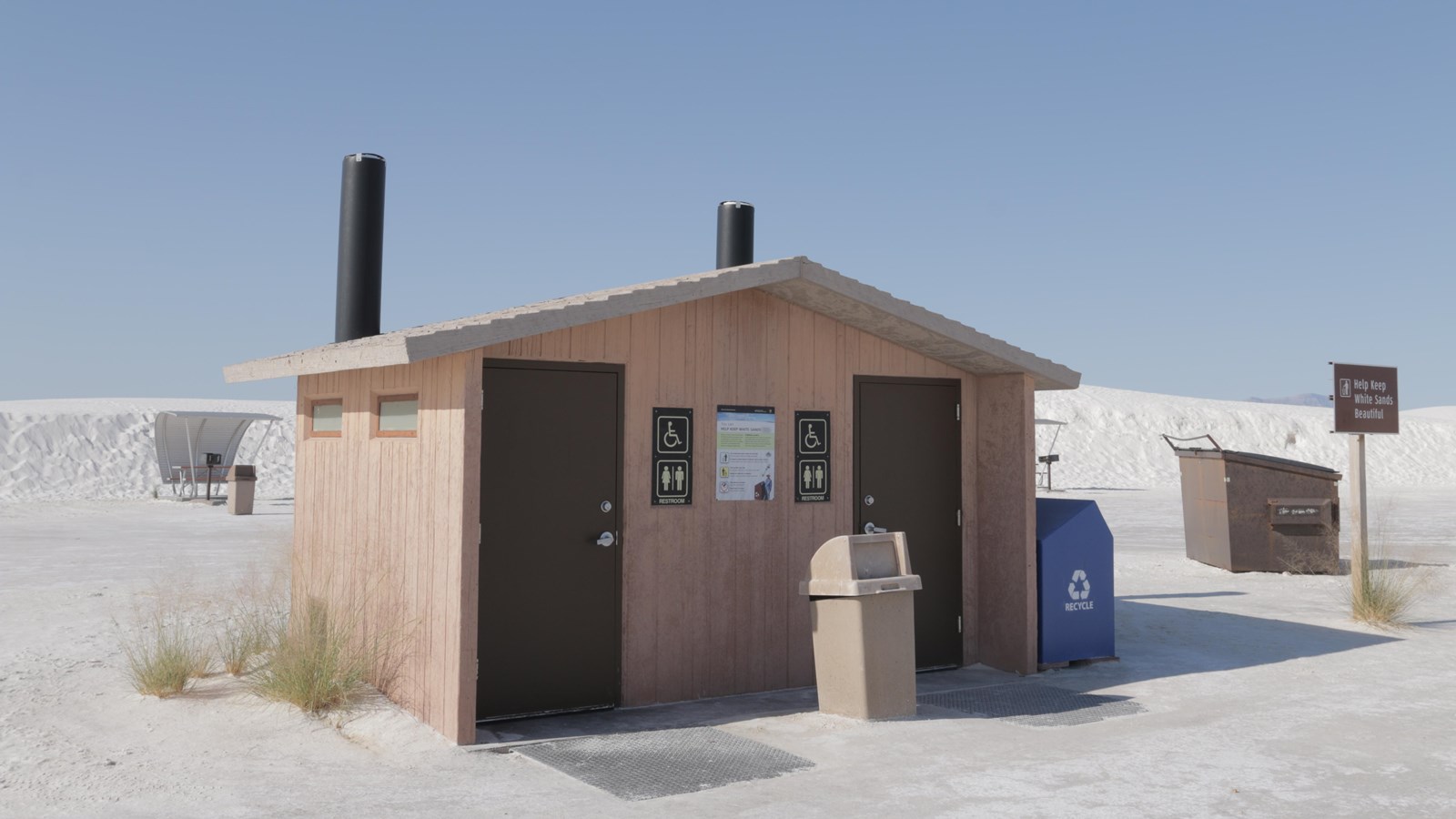 The Yucca Picnic Area restroom in the center of a ring of picnic tables.