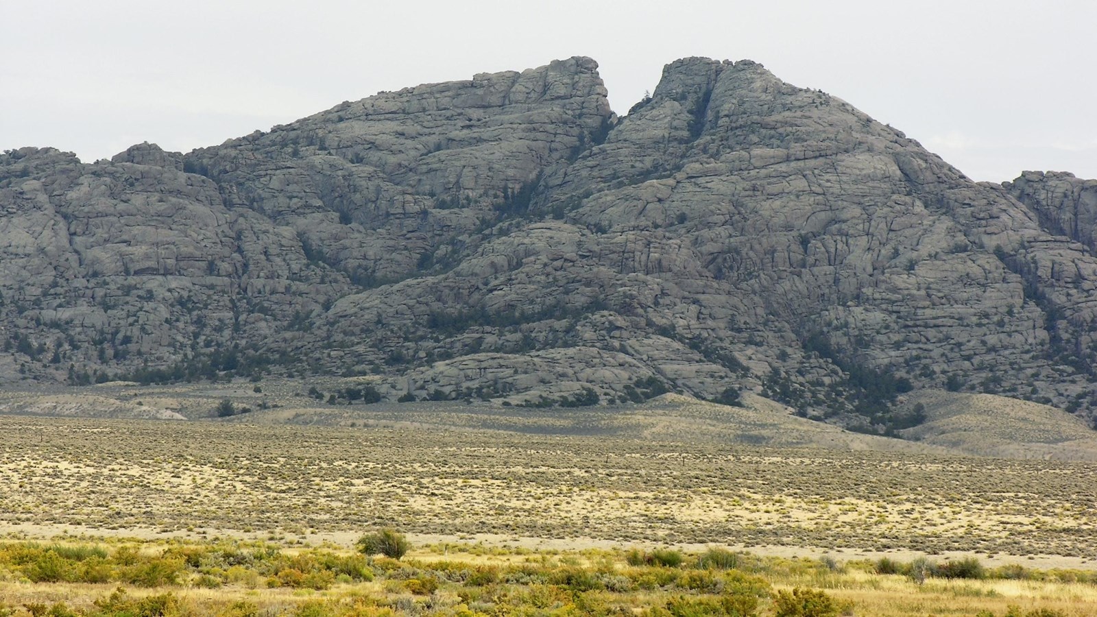 Large rock formation with a crack down the middle. 