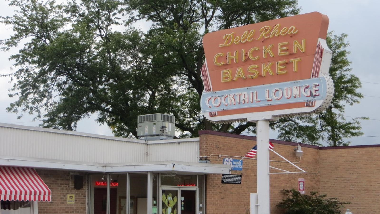 A tan brick building. A large sign reads 
