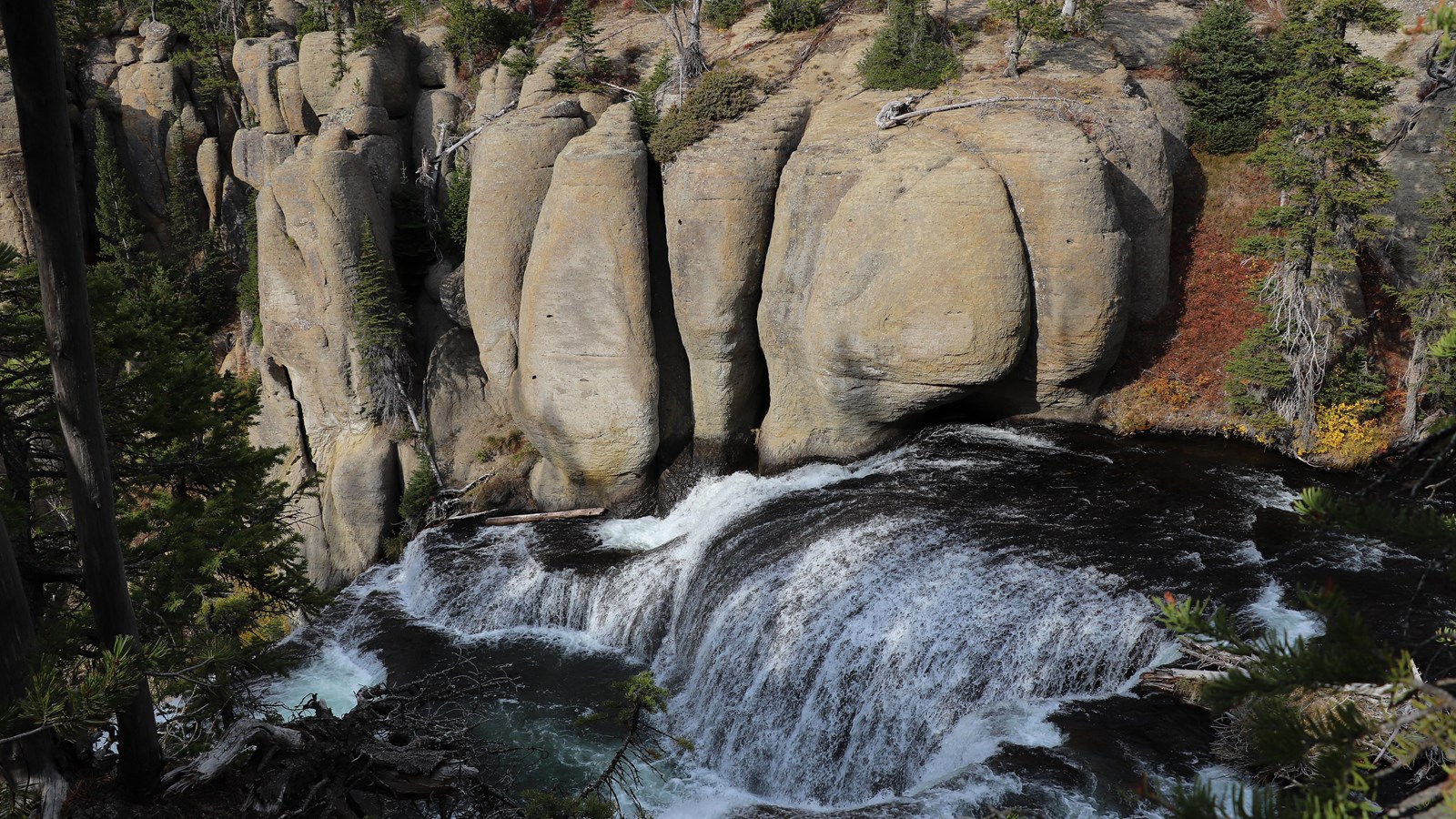 A creek cascades down terraces in a canyon.