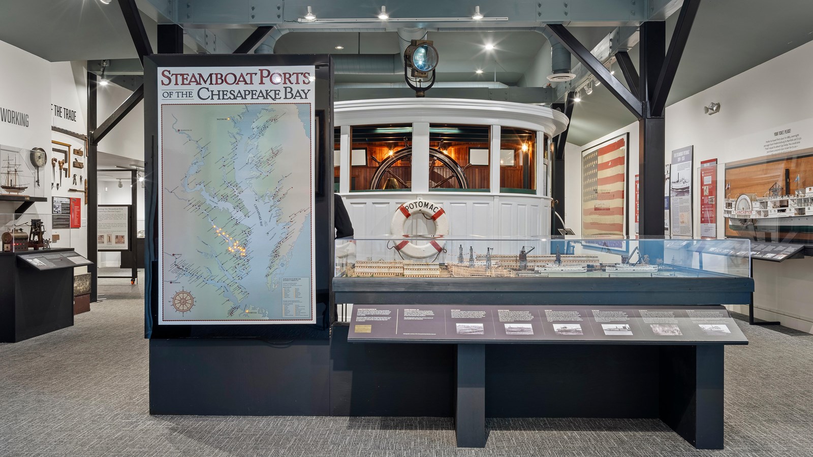 Museum exhibit with a Chesapeake Bay ports map, steamboat model, and steamboat cabin replica.