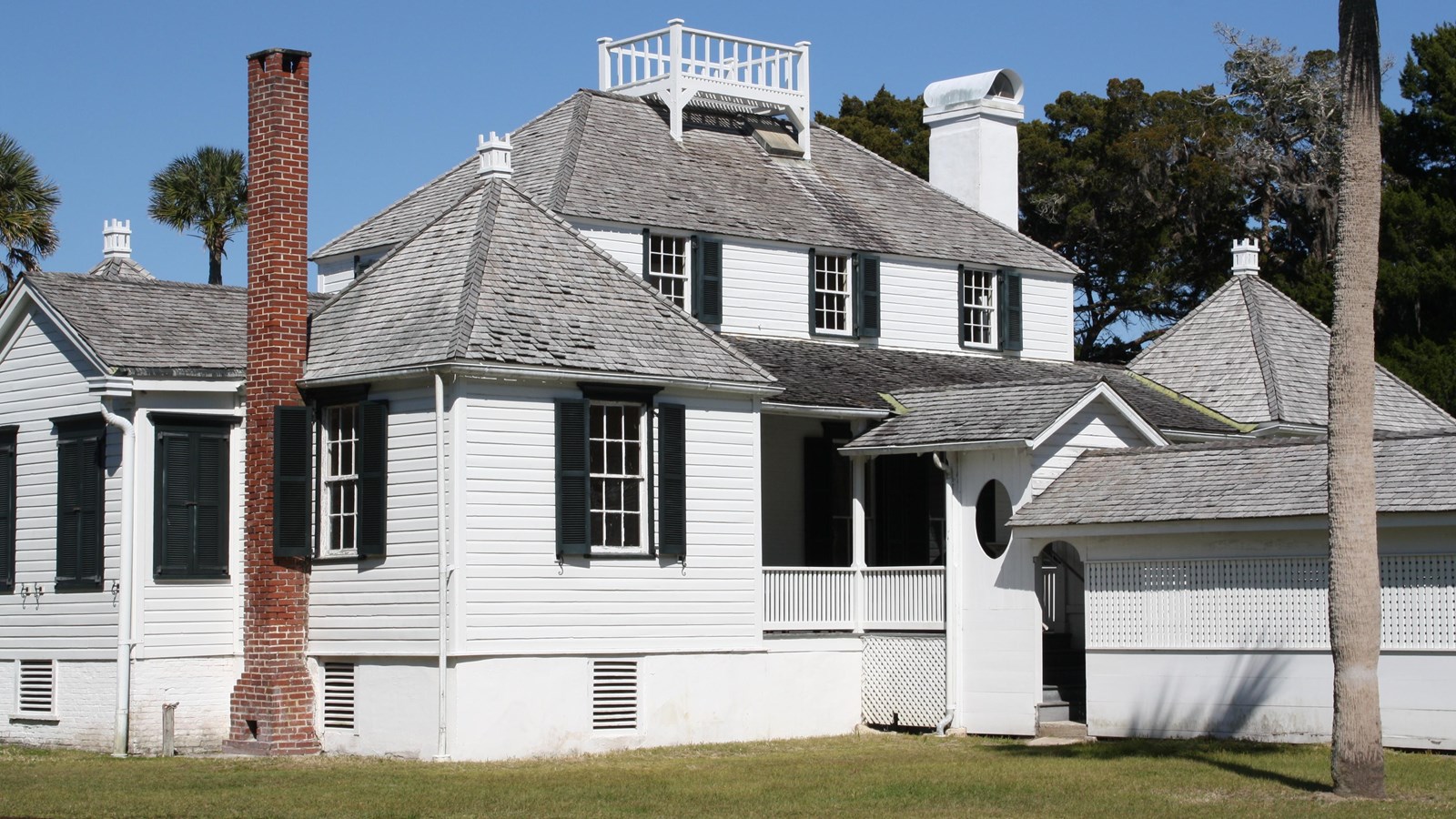 two story white building with black shutters