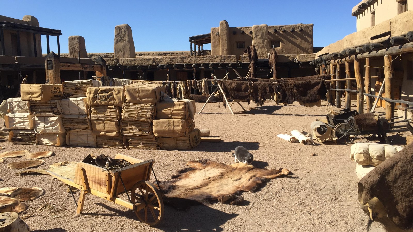 Stacks of bison robes, boxes and other items fill a rectangular space.