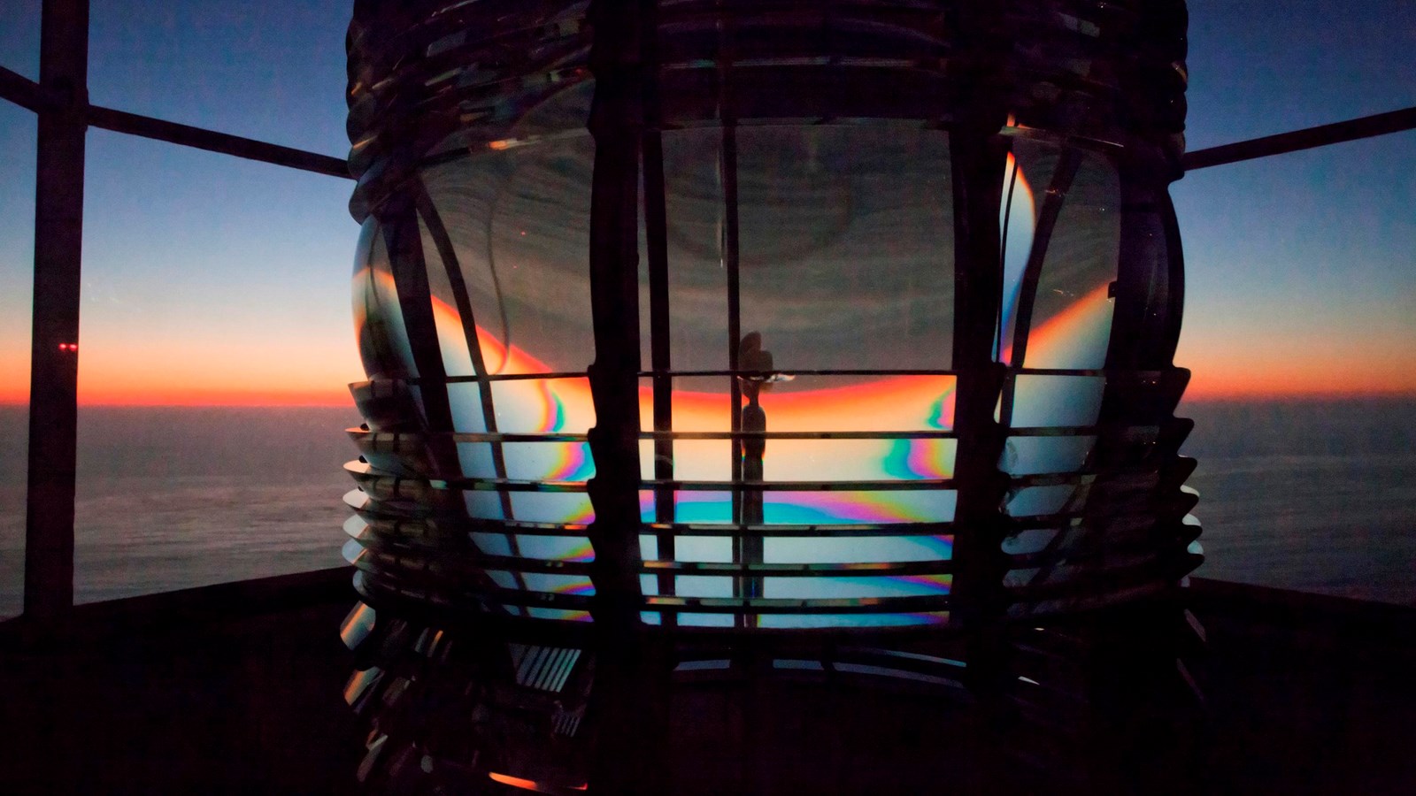 A large lantern surrounded by glass windows. 