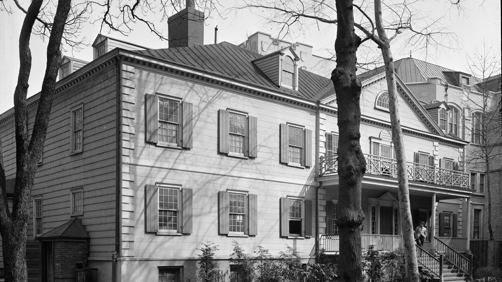 Exterior front of a two-story building with trees. Historic American Buildings Survey.