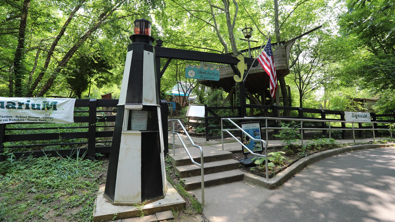 A model lighthouse stands over the gate of a 