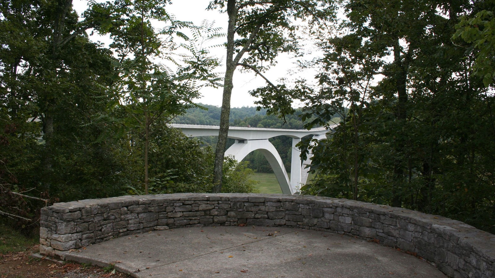 A view through the trees of the Double Arch Bridge