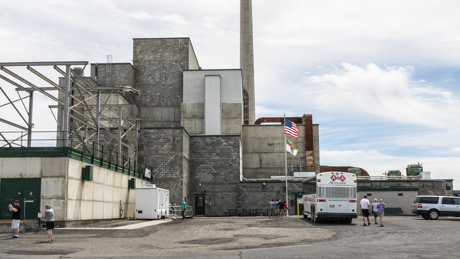 Color photograph of a very large industrial building composed of stacked concrete cubes