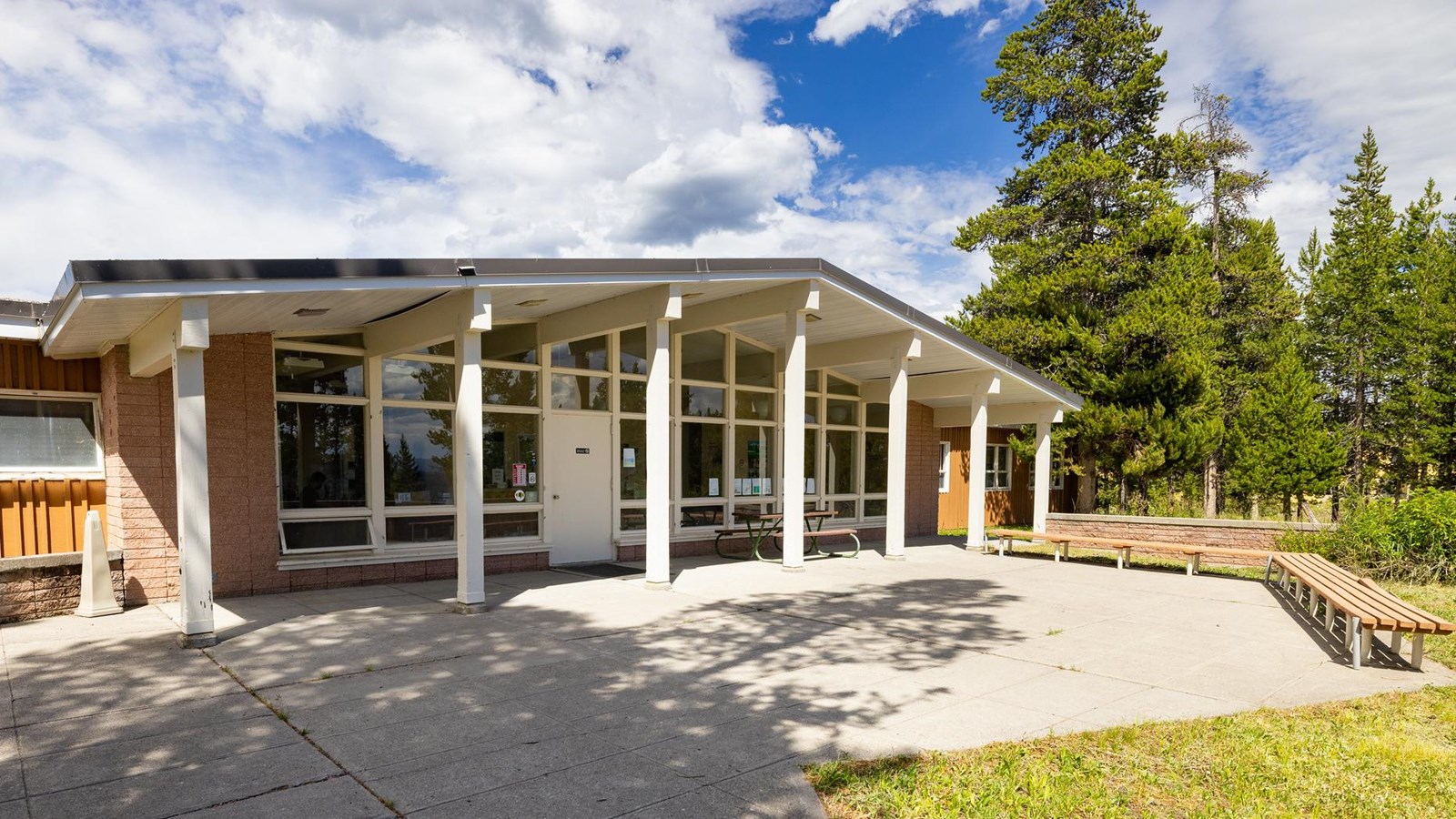 A brick building with large glass windows and a low roofline.