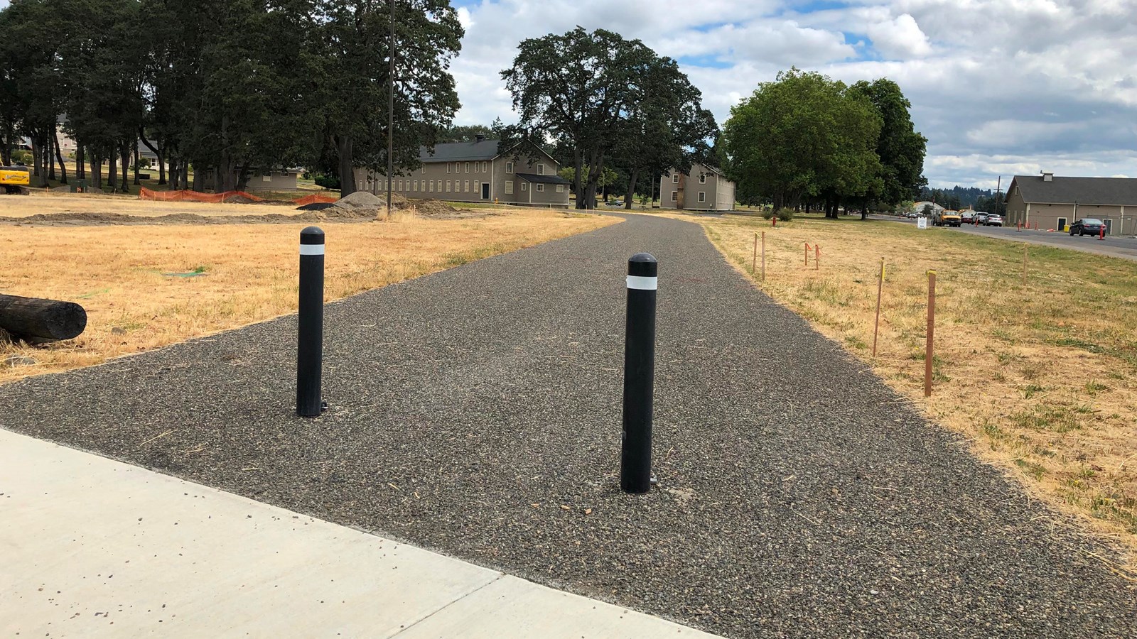 The entrance to Alvord Path, a paved path bordered by grassy areas.