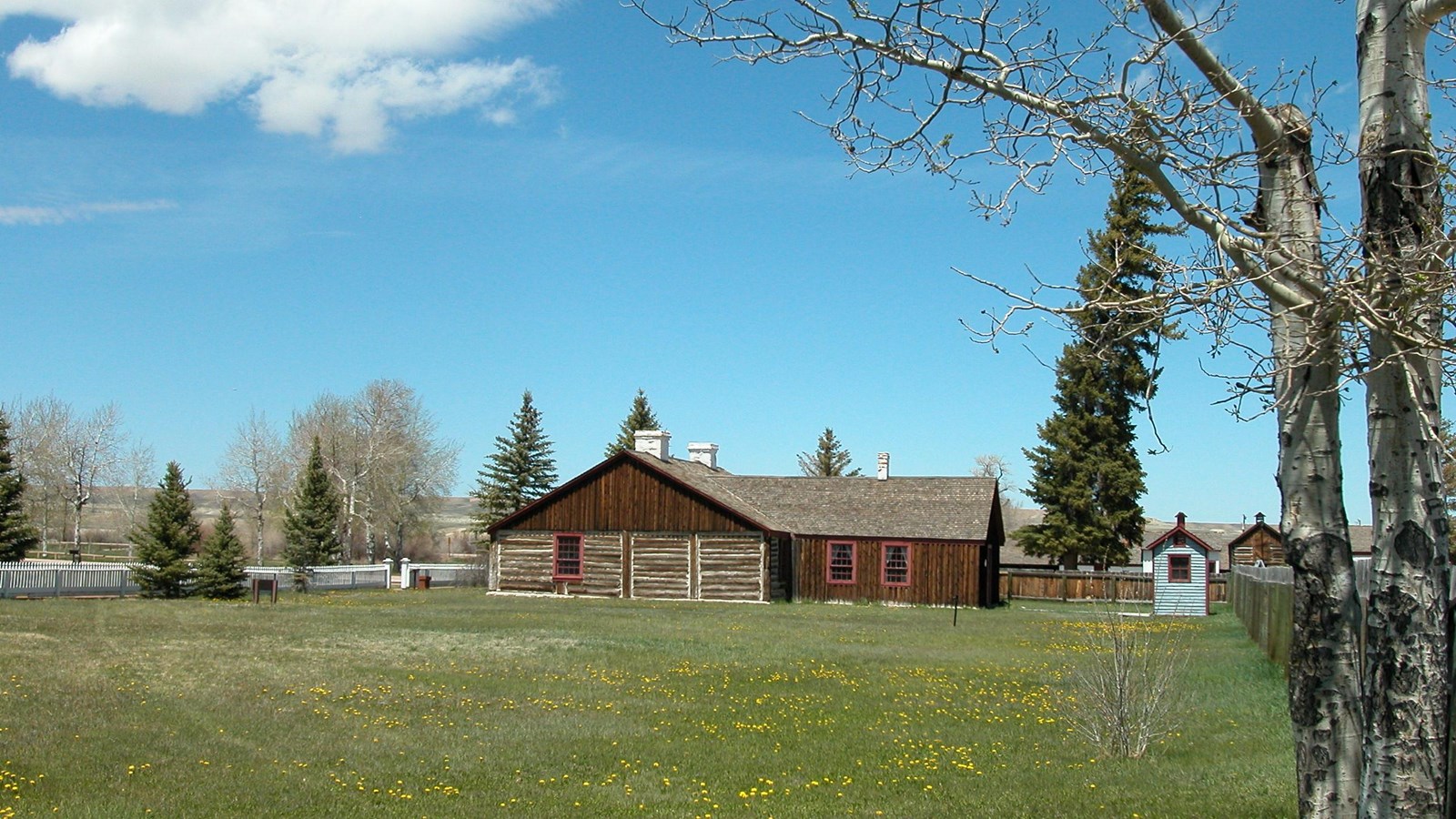 Looking across a lawn to a historic brick building.