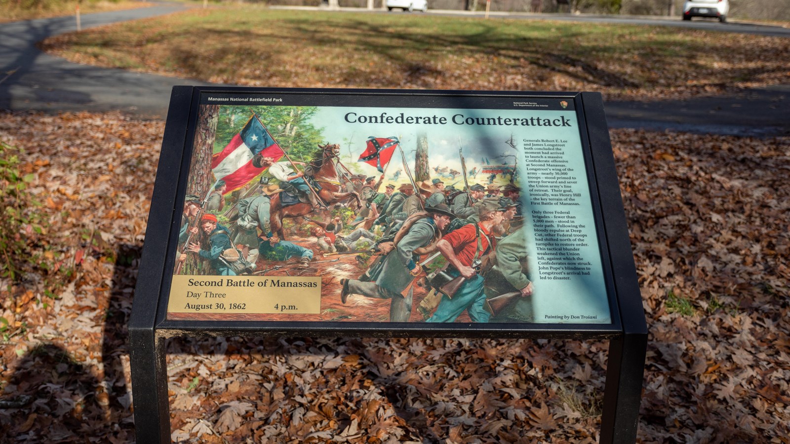 A drawing of Confederate troops running toward a field a depicted. Soldiers hold Confederate flags. 