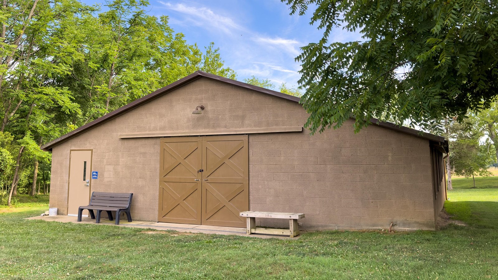 A brown-gray painted concrete barn.