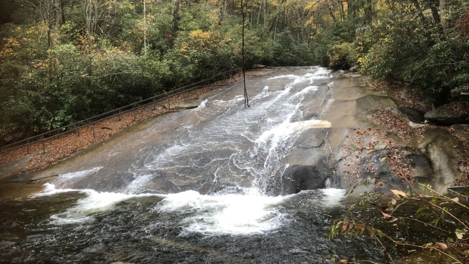 Rock face with water cascading into pool below