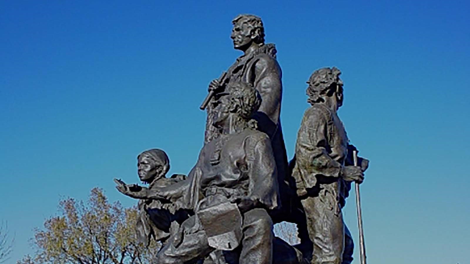 The Corps of Discovery, showing Lewis who is standing, Clark who is seated, York is facing away from
